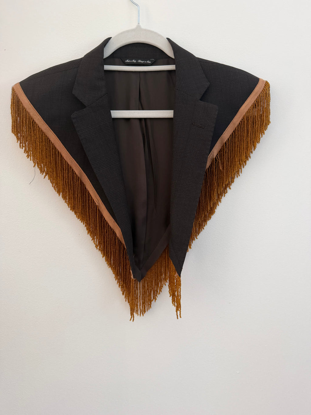 Capelet featuring fringe trim