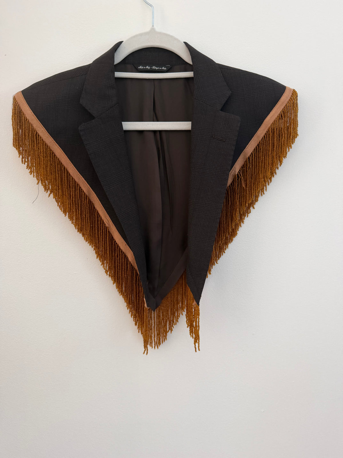 Capelet featuring fringe trim