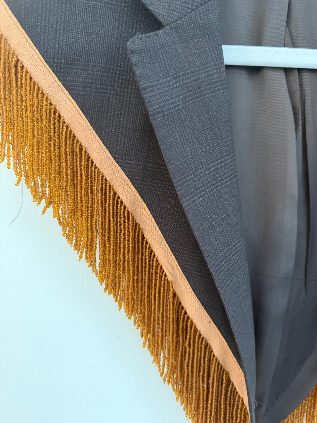 Capelet featuring fringe trim