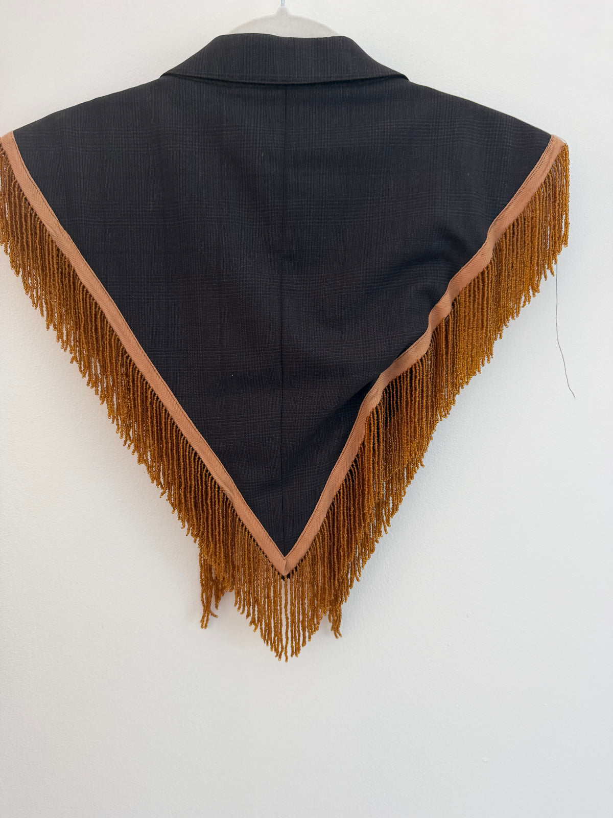 Capelet featuring fringe trim